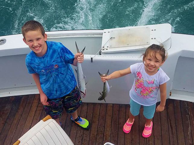 Two children anglers on a family friendly fishing charter.