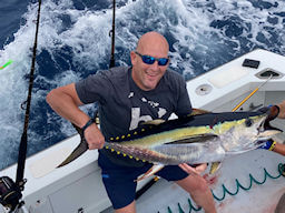 Happy Wild Card angler showing off a very colorful yellowfin tuna that he just caught.