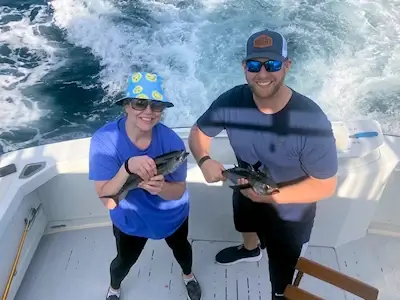 John and Savannah showing off a couple of the blackfin tuna they caught.