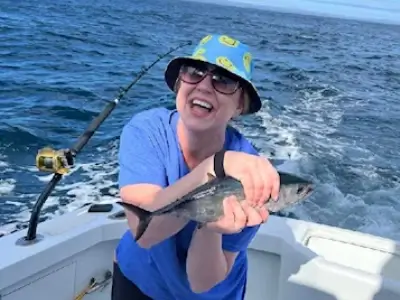 Savannah holds up a blackfin tuna caught during their honeymoon.